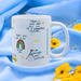 White ceramic mug with positive affirmations including "Today I will take small steps to a wonderful future" and "I am stronger than yesterday", featuring hand-drawn rainbow and mountain illustrations, styled with blue fabric and yellow flowers.